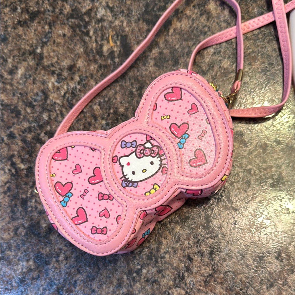 First off, wins Hello Kitty Pink Bow-Shaped Bag with Heart Design